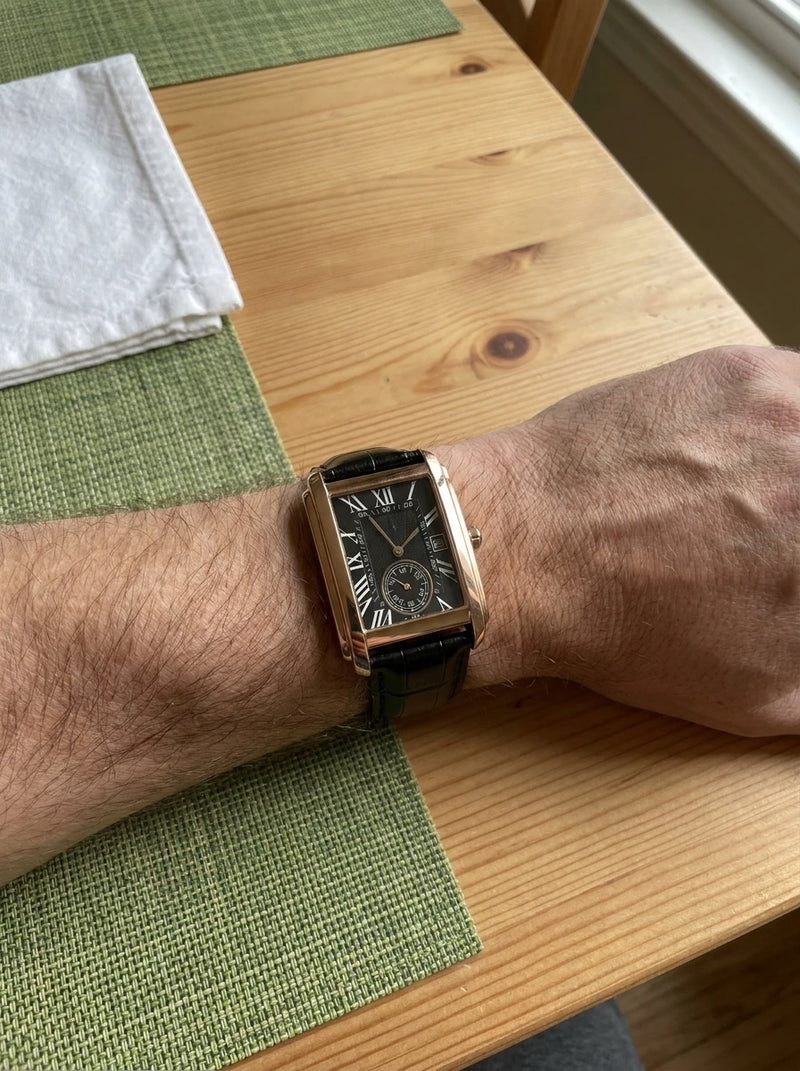 The Founder rose-gold tank watch on the wrist, black dial
